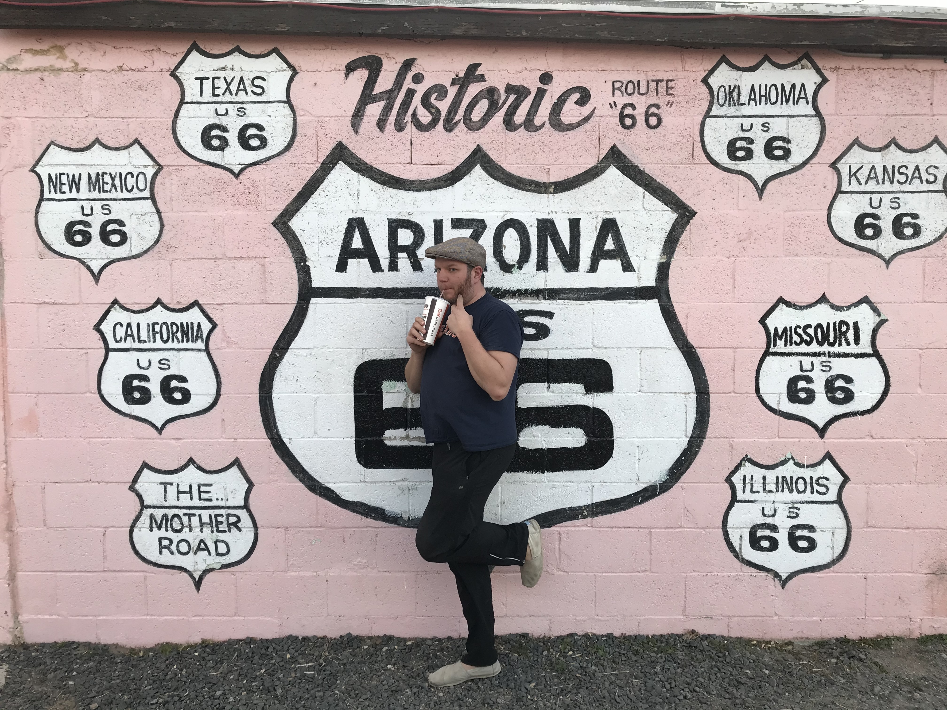 Matthew standing in front of a historic Route 66 mural